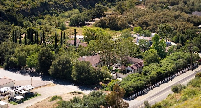 drone / aerial view with a wooded view