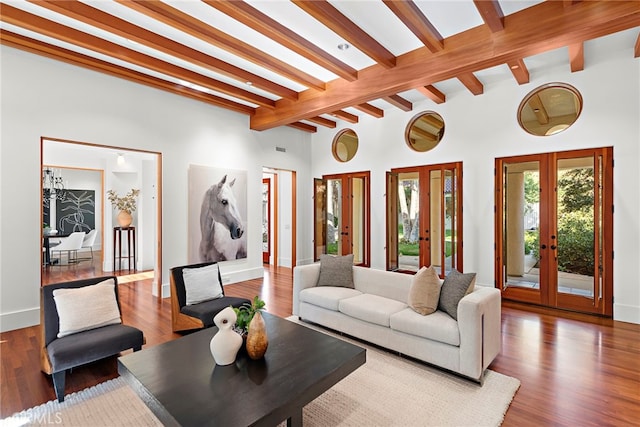 living room featuring beam ceiling, baseboards, wood finished floors, and french doors