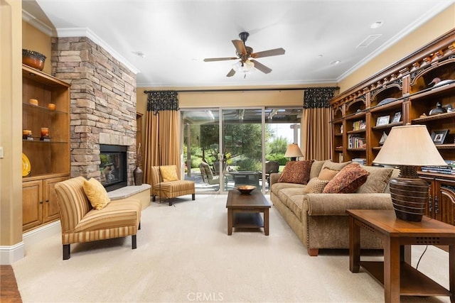 living area with ornamental molding, light colored carpet, a fireplace, and ceiling fan