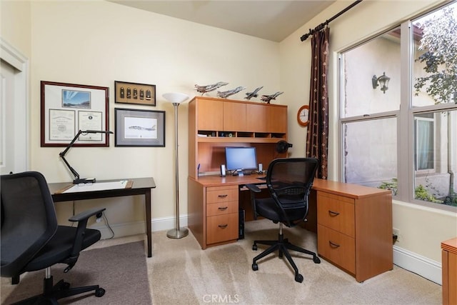 home office featuring light carpet and baseboards