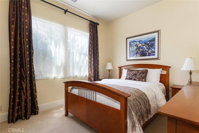 carpeted bedroom with baseboards