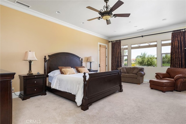 carpeted bedroom featuring crown molding and ceiling fan