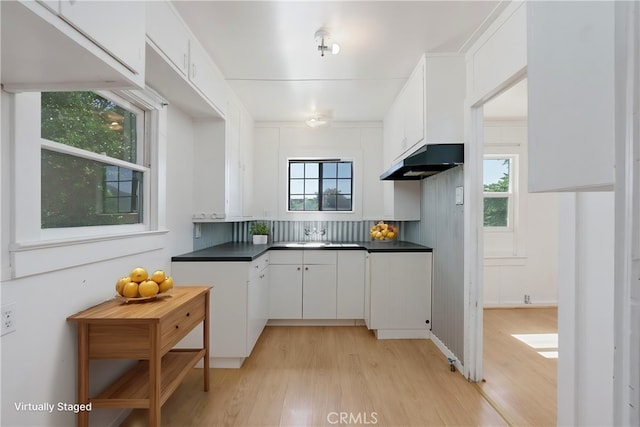 kitchen with white cabinetry, light hardwood / wood-style floors, and sink