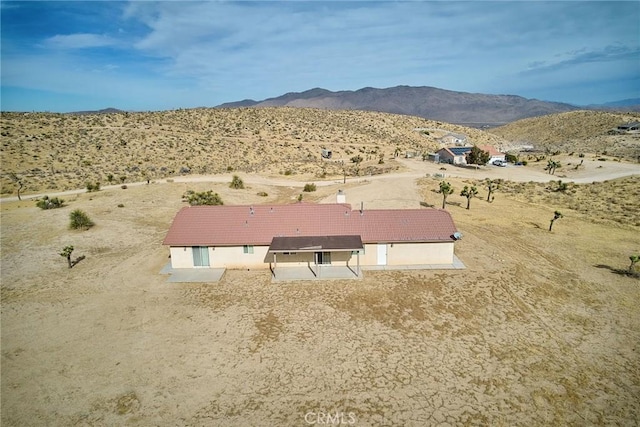 birds eye view of property with a mountain view