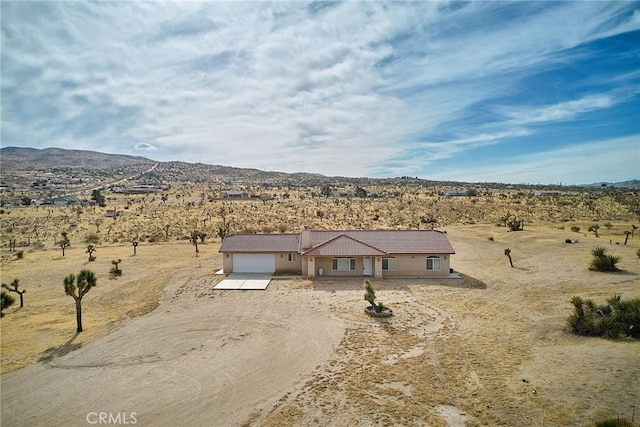 view of front of house with a garage and a mountain view