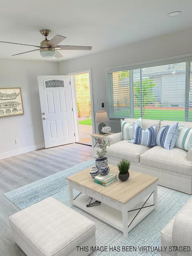 living room with light hardwood / wood-style floors and ceiling fan