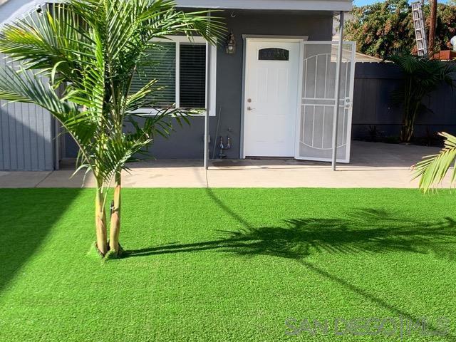 exterior space with a patio area and a lawn