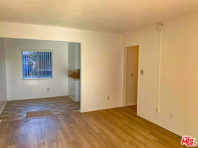 unfurnished room featuring hardwood / wood-style flooring