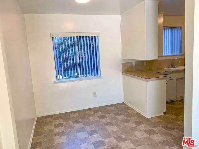 kitchen with sink and white cabinetry