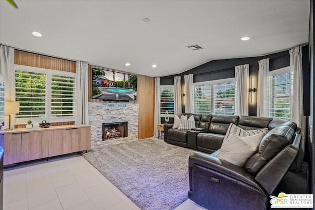 living room with lofted ceiling, a fireplace, and a healthy amount of sunlight