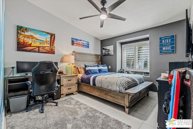 bedroom featuring ceiling fan, vaulted ceiling, and light tile patterned flooring