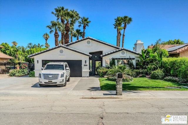 view of front of home with a front yard and a garage