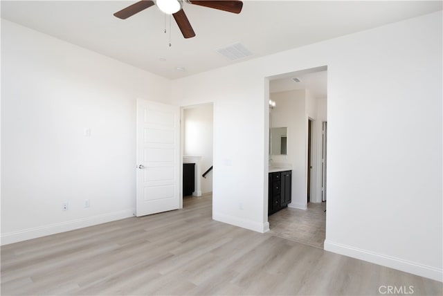 unfurnished room with light wood-type flooring and ceiling fan