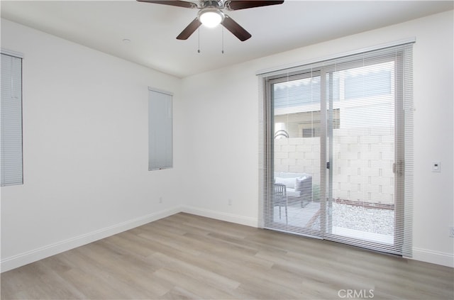 spare room featuring light hardwood / wood-style floors and ceiling fan