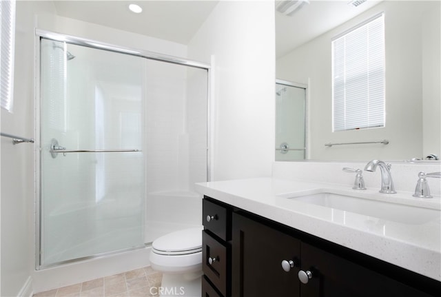 bathroom with vanity, toilet, and an enclosed shower