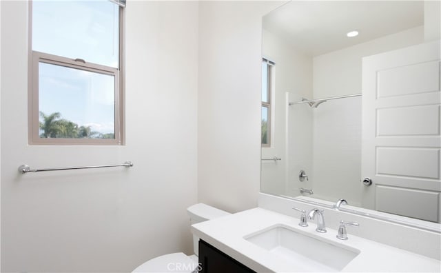 full bathroom featuring vanity, washtub / shower combination, and toilet