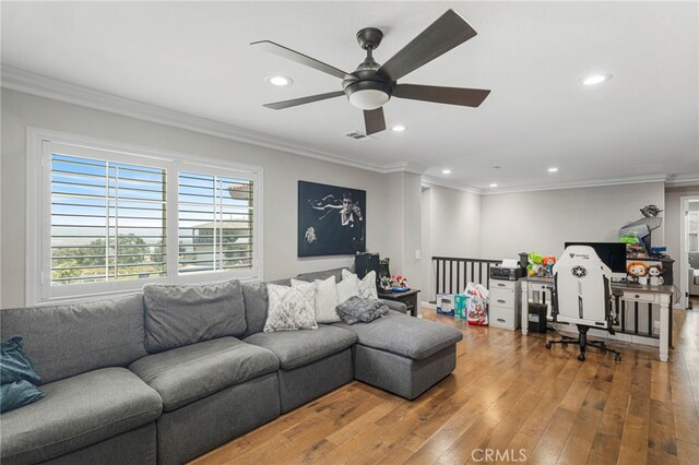 living room featuring ceiling fan, ornamental molding, and hardwood / wood-style floors