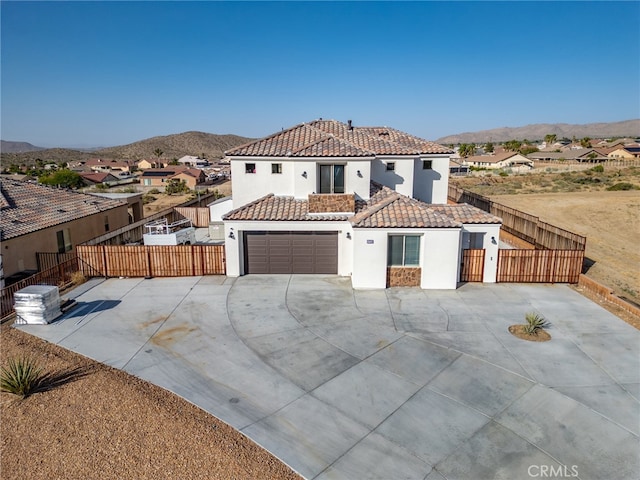 mediterranean / spanish-style house featuring a mountain view and a garage