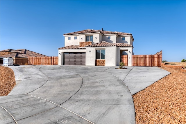 mediterranean / spanish-style home with a garage