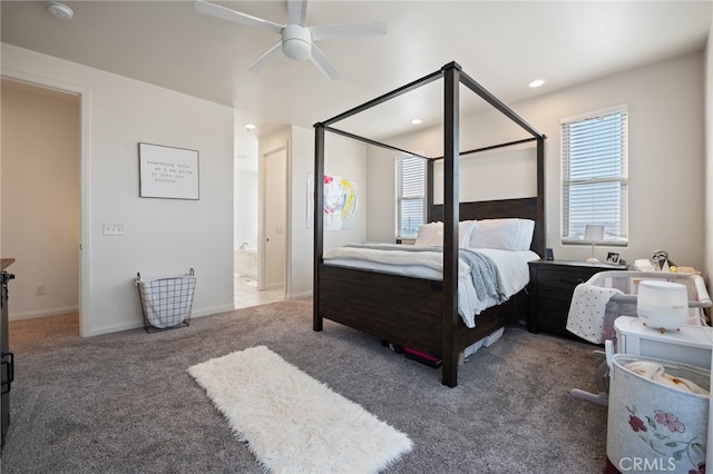 bedroom featuring dark colored carpet, ceiling fan, and ensuite bathroom