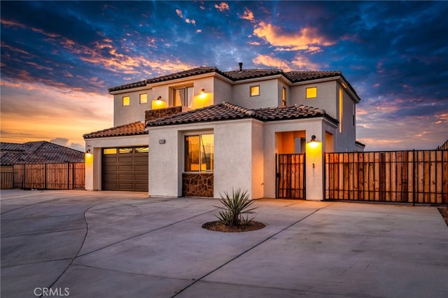 mediterranean / spanish-style house with a garage