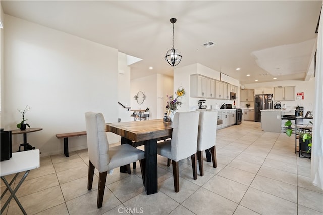 dining room with light tile patterned floors and a chandelier