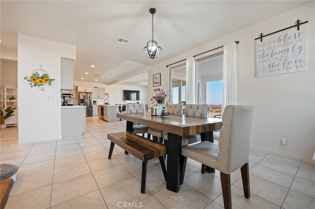 tiled dining room with a notable chandelier