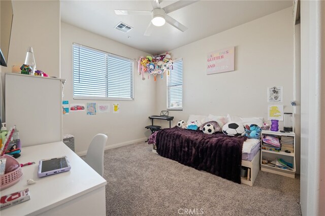 bedroom featuring carpet flooring, multiple windows, and ceiling fan