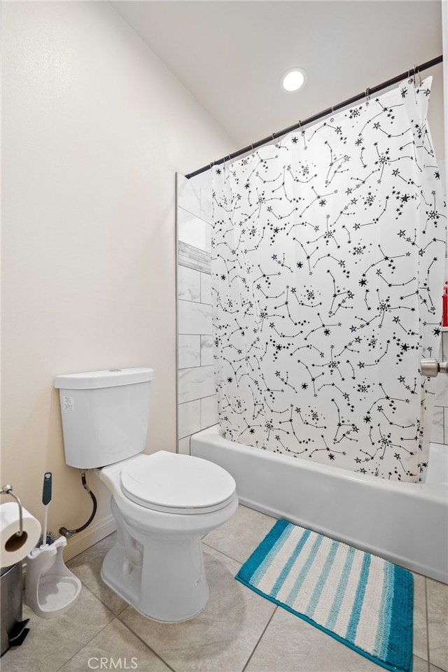 bathroom featuring shower / tub combo with curtain, toilet, and tile patterned floors