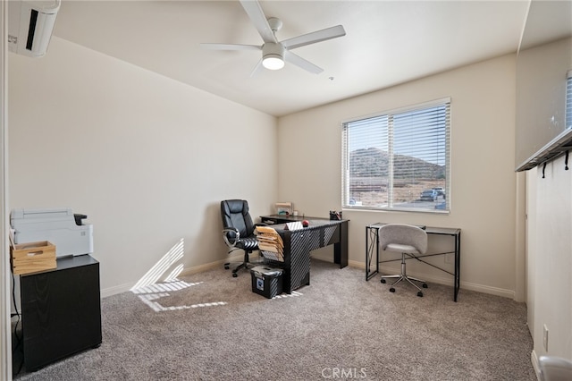 carpeted office space featuring ceiling fan