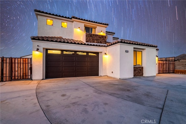 mediterranean / spanish-style house featuring a garage