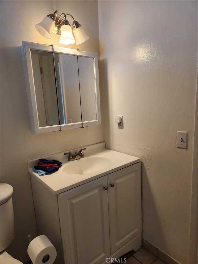 bathroom with vanity, toilet, and tile patterned floors