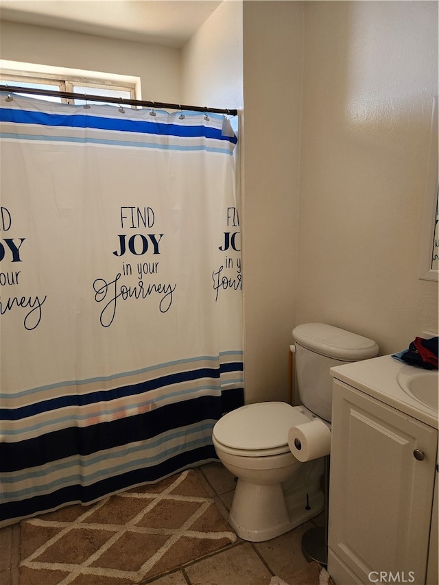 bathroom featuring vanity, toilet, tile patterned floors, and a shower with shower curtain