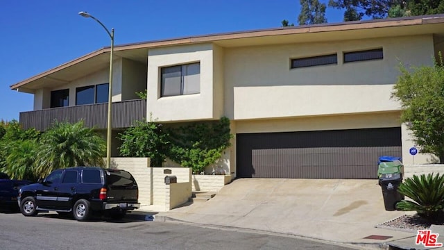 view of front facade featuring a balcony and a garage