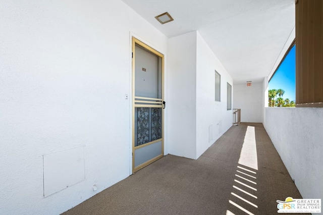 hallway with carpet floors