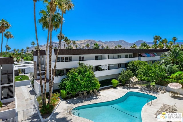 view of pool featuring a mountain view and a patio area