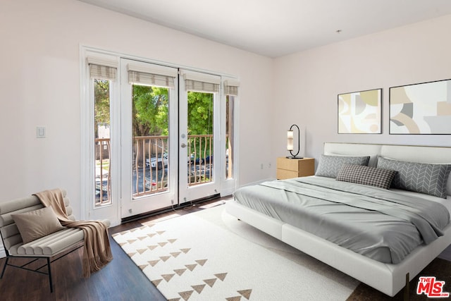 bedroom featuring wood-type flooring and access to outside