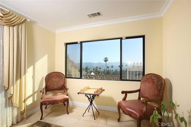 sitting room with a mountain view and crown molding