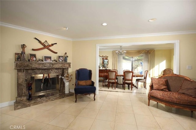 sitting room featuring light tile patterned floors, an inviting chandelier, crown molding, and a premium fireplace