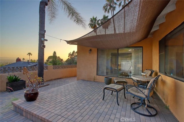 view of patio terrace at dusk