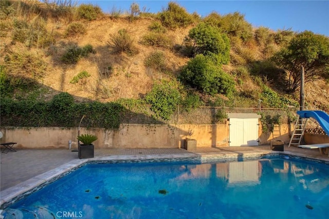 view of pool with a patio area and a water slide