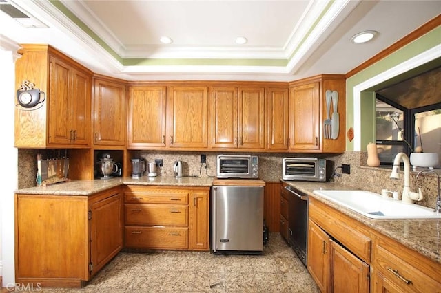 kitchen with backsplash, sink, appliances with stainless steel finishes, and ornamental molding