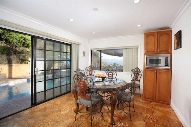 dining space featuring crown molding