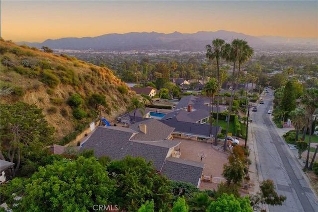 aerial view at dusk featuring a mountain view