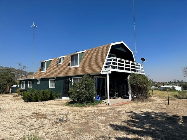 back of property with a balcony