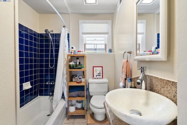 full bathroom with shower / tub combo, tile patterned flooring, toilet, and sink