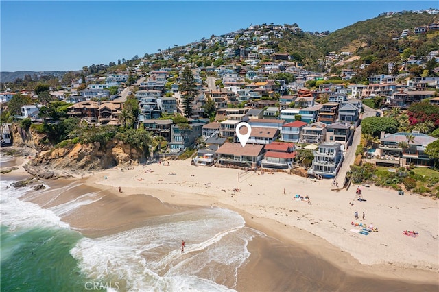 drone / aerial view with a water view and a view of the beach