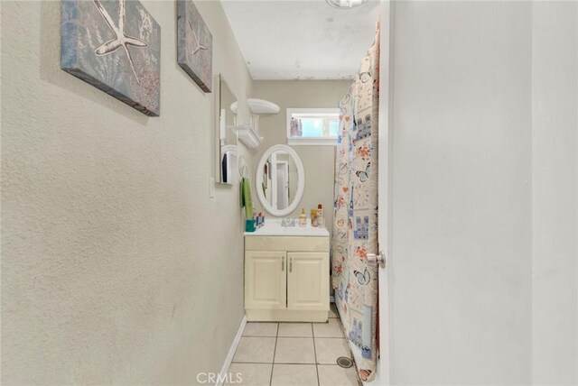 bathroom featuring tile patterned flooring and vanity