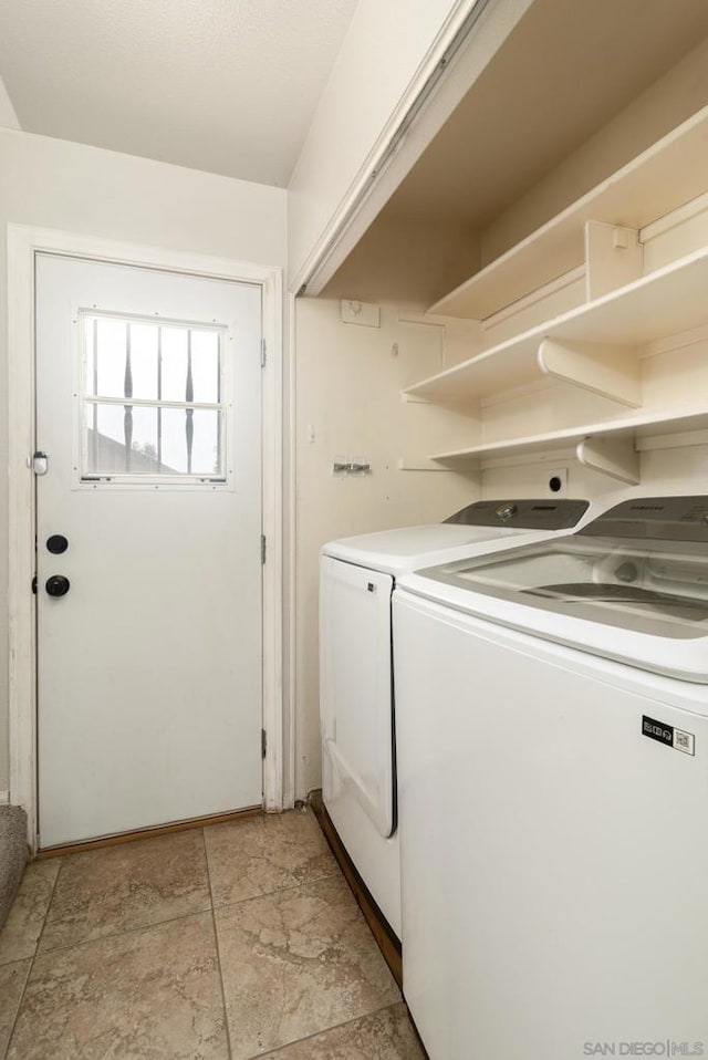 clothes washing area featuring washer and dryer