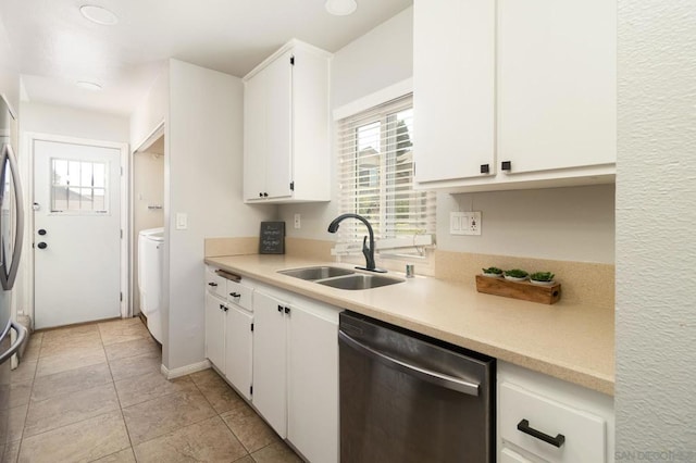 kitchen with stainless steel dishwasher, white cabinetry, sink, and light tile patterned floors